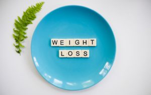 Blue plate containing the words 'weight loss'.